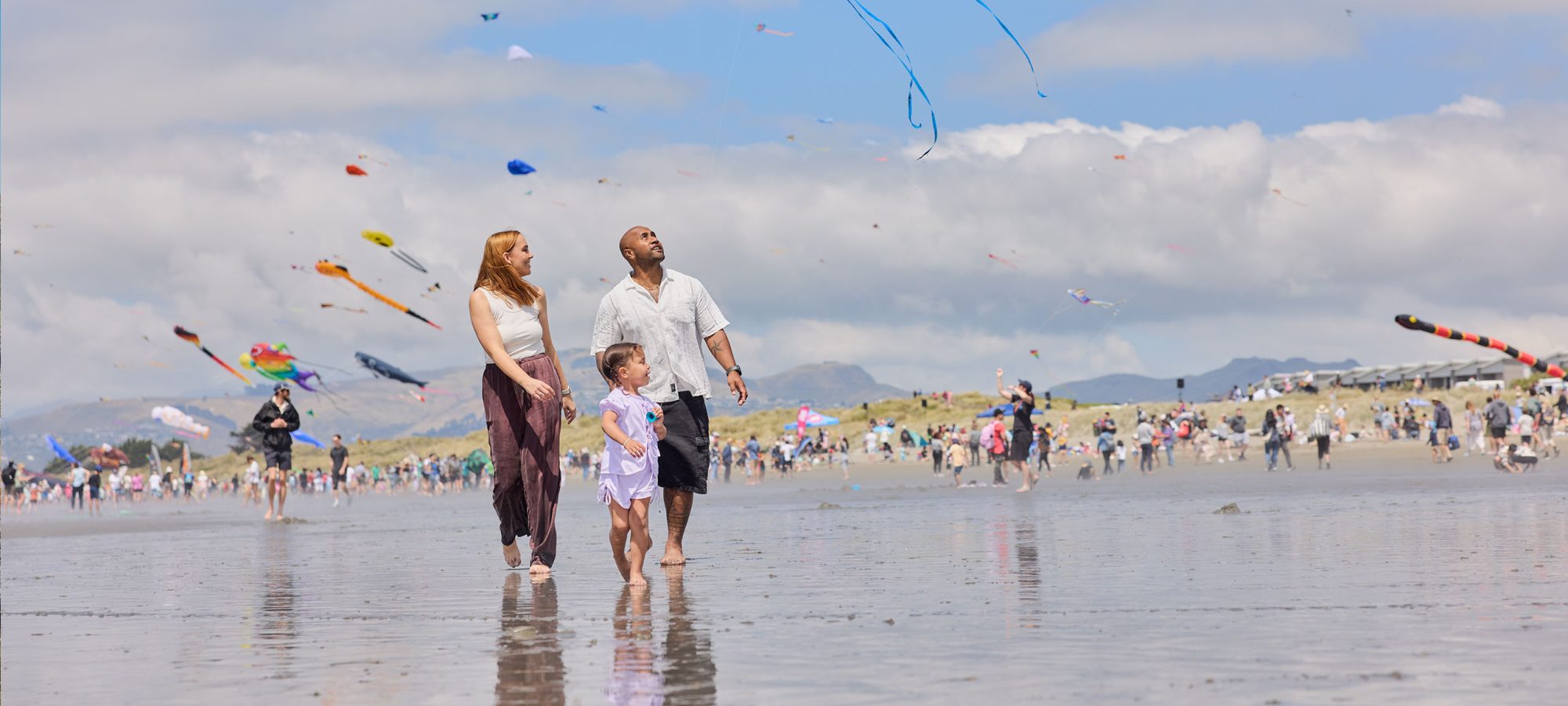 New-Brighton-Kite-Festival-Family-Walking-on-Beach-credit-Christchurch-Tourism-Banner