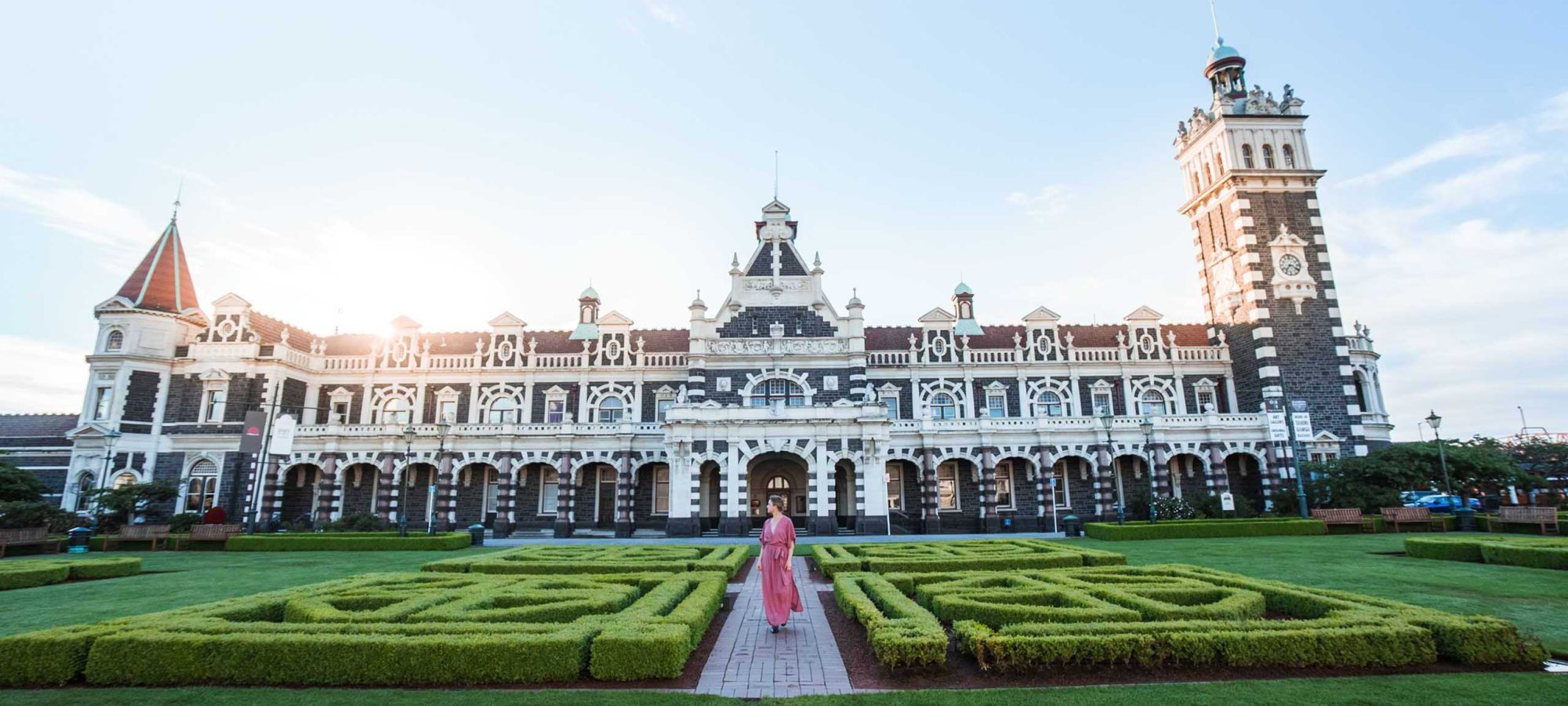 Region-Dunedin-Otago-Railway-Station-Building-Gardens-People-Sunset-Banner