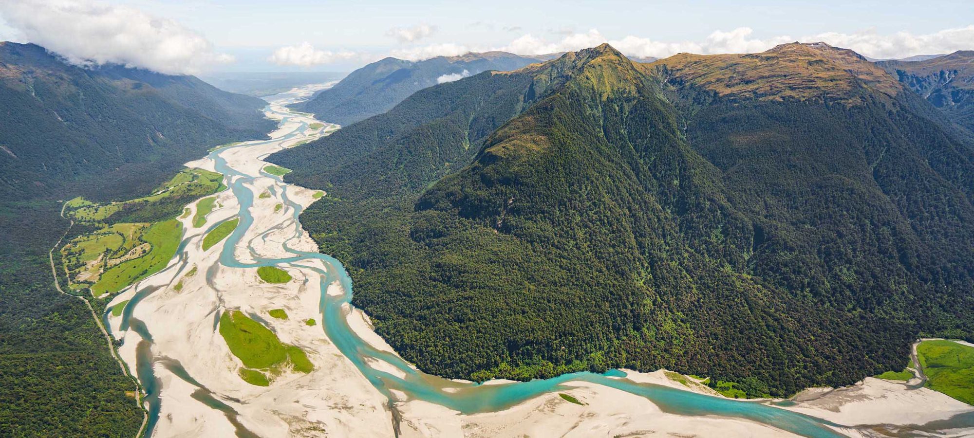 Region-West-Coast-Helicopter-Flight-View-River-Mountains-Banner