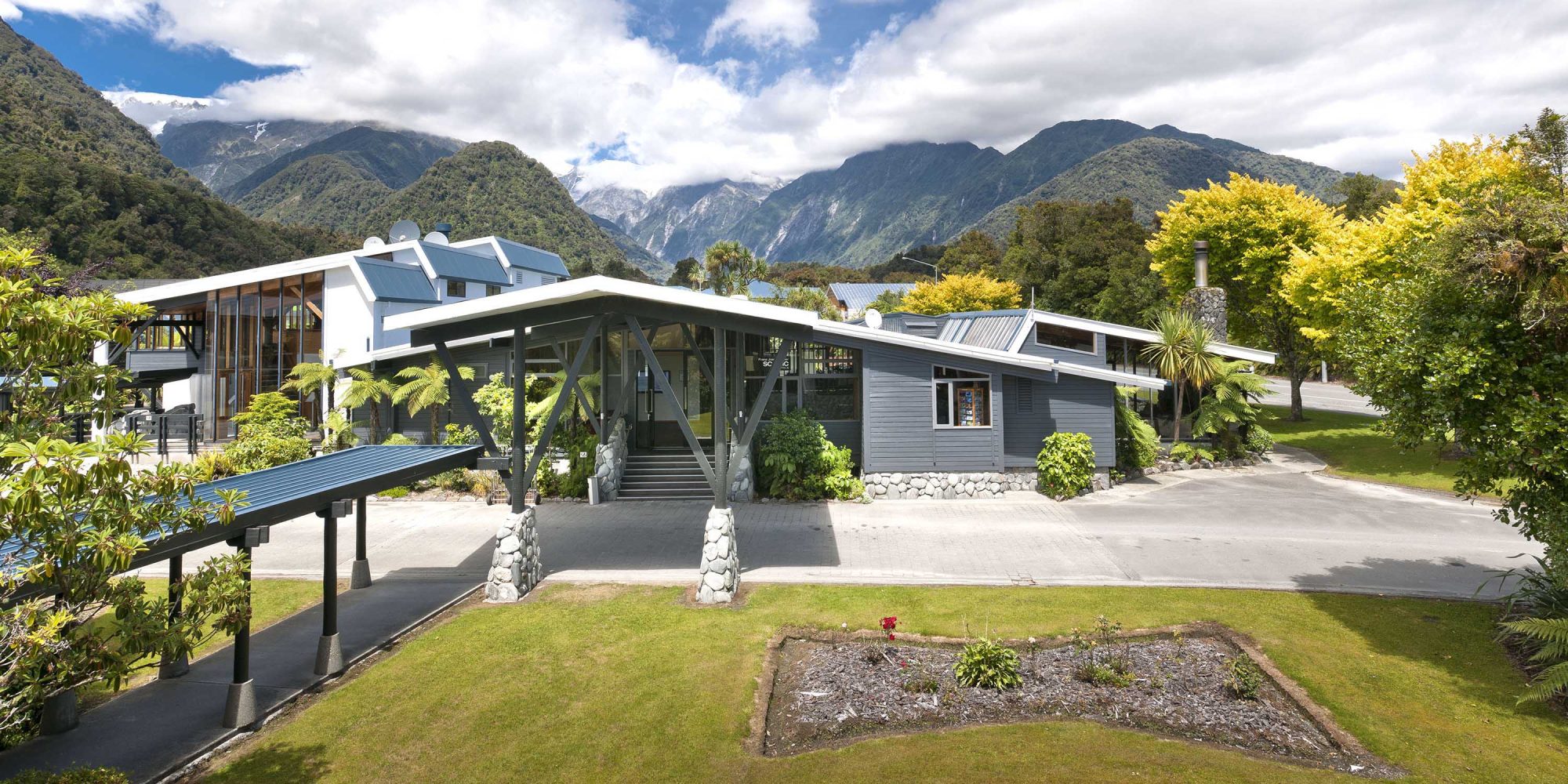 Scenic-Hotel-Franz-Josef-Glacier-Exterior-Grounds-View-Banner