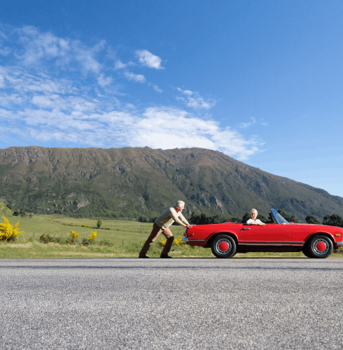 Senior pushing red convertible-small