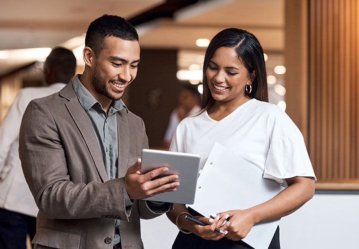 Two-People-Viewing-Tablet-Corporate-Small